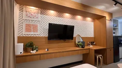 a living room with a flat screen tv on a wall at Lemmon's Casita in Manila