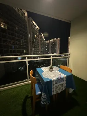 a table on a balcony with a view of a city at Azure Urban Beach Residences with PS4 near Airport in Manila