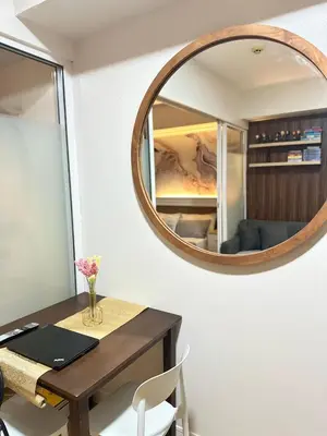 a room with a table with a mirror on the wall at Azure Urban Beach Residences with PS4 near Airport in Manila