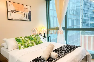 a bedroom with a bed with a large window at Chic BGC Condo Across Uptown Mall #ournw9b in Manila