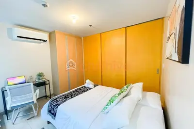 a bedroom with a large white bed and a desk at Chic BGC Condo Across Uptown Mall #ournw9b in Manila