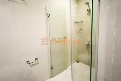 a shower with a glass door in a bathroom at Chic BGC Condo Across Uptown Mall #ournw9b in Manila