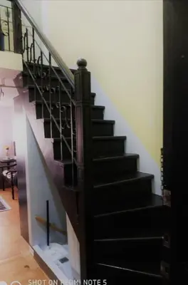 a staircase in a house with a black stair case at Royal loft with breakfast options in Cainta