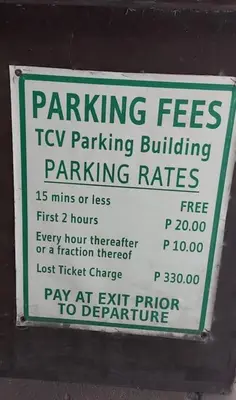 a parking fees sign on a parking meter at Royal loft with breakfast options in Cainta