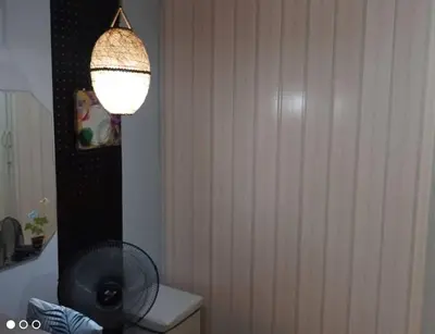 a bathroom with a fan on top of a toilet at Royal loft with breakfast options in Cainta