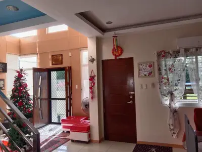 a living room with a christmas tree and a door at Entire house in high end subdivision in Antipolo