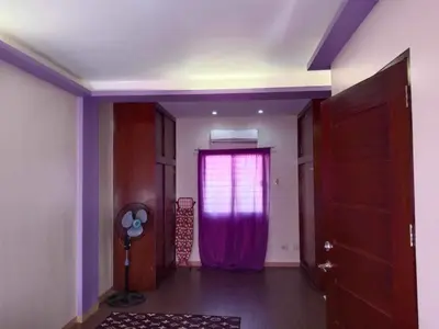 a room with a purple curtain and a window at Entire house in high end subdivision in Antipolo