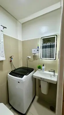 a small bathroom with a sink and a mirror at The GoodVibes Condotel Red Residences Makati in Manila