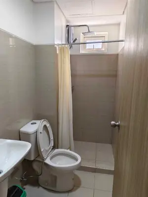 a bathroom with a white toilet and a sink at Shore Res 2 Br 2Bath 1417 in Manila
