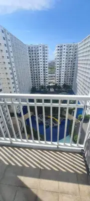 a white railing on a balcony with tall buildings at Shore Res 2 Br 2Bath 1417 in Manila