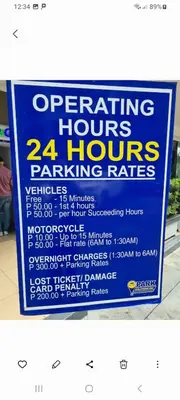 a sign foroperating hours hours parking rates at Shore Res 2 Br 2Bath 1417 in Manila