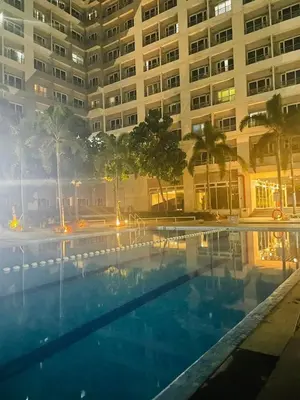 a swimming pool in front of a large building at SMDC Grace Residences in Manila