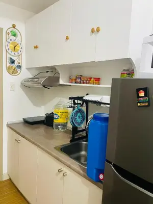 a kitchen with a sink and a refrigerator at SMDC Grace Residences in Manila