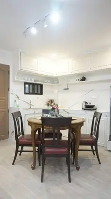 a kitchen with a wooden table and chairs in a room at 4-5br Apartment in Paranaque for Staycation in Manila
