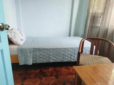 a small bedroom with a bed and a chair at 4-5br Apartment in Paranaque for Staycation in Manila