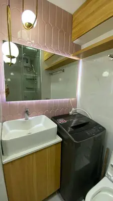 a small bathroom with a sink and a trash can at Enchanted Gateway by Shore 3 in Manila