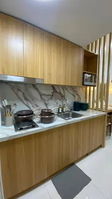a kitchen with a stove and a sink with pots and pans at Enchanted Gateway by Shore 3 in Manila