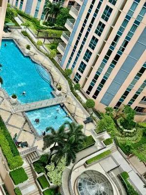 an overhead view of a swimming pool in front of a building at Bell Place at Venice Luxury Mckinley Hill in Manila