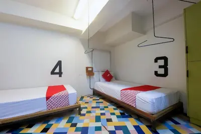 two beds in a room with numbers on the wall at Spot On Junction Hostel in Manila
