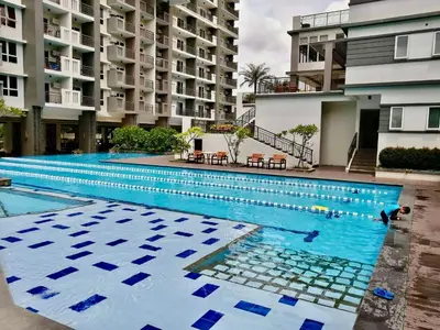a large swimming pool in front of a building at Rys Sheridan Tower Mandaluyong in Manila