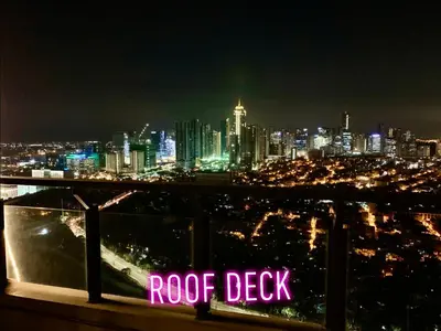 a view of a city skyline at night at Rys Sheridan Tower Mandaluyong in Manila