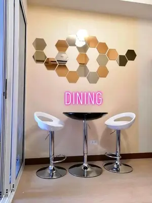 a bar with two stools and a dining sign on the wall at Rys Sheridan Tower Mandaluyong in Manila