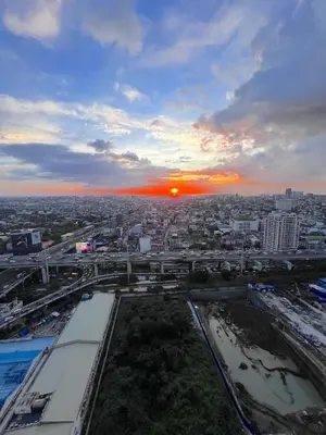 a view of a city with the sunset in the background at Cozy 1 BR San Lorenzo Place Netflix 4KM NAIA in Manila