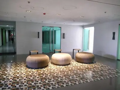two circular stools in a room with a floor at Cozy 1 BR San Lorenzo Place Netflix 4KM NAIA in Manila