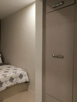a bedroom with a bed and a door with a drawer at Adria Residences - Diamond Garden - 2 Bedroom Unit for 4 Person in Manila