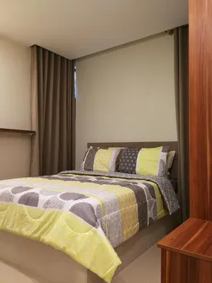 a bedroom with a bed with yellow and gray blankets at Adria Residences - Diamond Garden - 2 Bedroom Unit for 4 Person in Manila