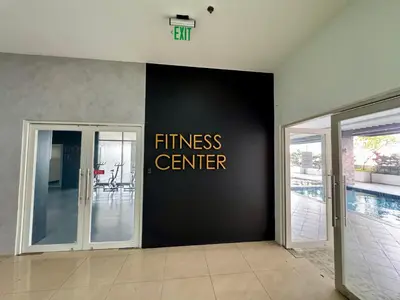 a hallway with a fitness center sign on a wall at AMA Tower Studio, 8th flr, near DMW and SM Megamall in Manila