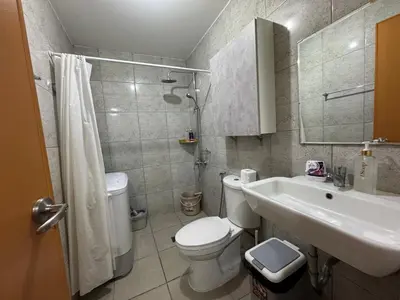 a bathroom with a white toilet and a sink at AMA Tower Studio, 8th flr, near DMW and SM Megamall in Manila