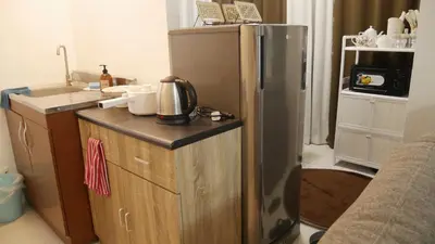 a kitchen with a stainless steel refrigerator and a counter at Experience Santa Rosa Comfort at MEGAN Montagne Suite in Santa Rosa