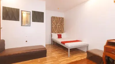 a small room with a bed and a couch at RedDoorz at Prince Hotel near NAIA T1 in Manila