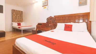 a hotel room with a bed and a desk at RedDoorz at Prince Hotel near NAIA T1 in Manila