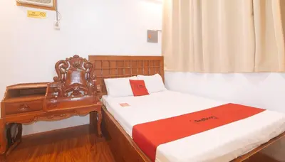 a bedroom with two beds and a dresser and a window at RedDoorz at Prince Hotel near NAIA T1 in Manila