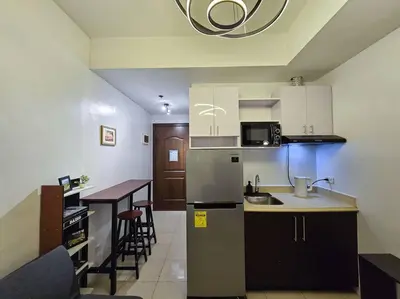 a kitchen with a table and a counter top at 1BR Condotel Ridgewood Towers Taguig City #RW02 in Manila