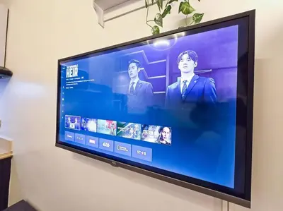 a flat screen tv hanging on a wall at 1BR Condotel Ridgewood Towers Taguig City #RW02 in Manila