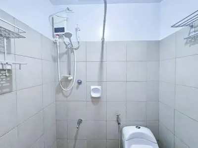 a white bathroom with a shower and a toilet at 1BR Condotel Ridgewood Towers Taguig City #RW02 in Manila