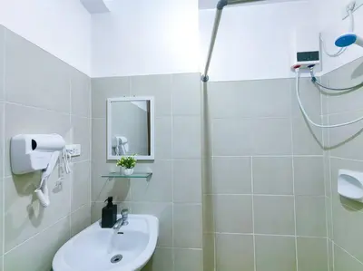 a white bathroom with a shower and a sink at 1BR Condotel Ridgewood Towers Taguig City #RW03 in Manila