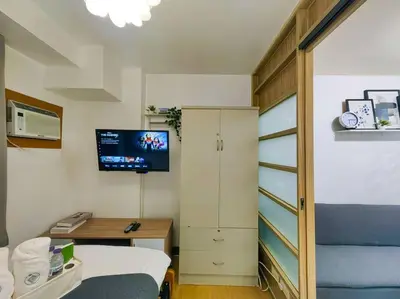 a room with a bed and a desk and a tv at 1BR Condotel Ridgewood Towers Taguig City #RW03 in Manila