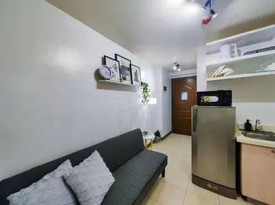 a living room with a couch and a kitchen at 1BR Condotel Ridgewood Towers Taguig City #RW03 in Manila