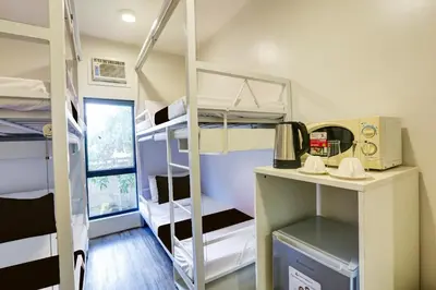 a room with bunk beds in a dorm room at Spot On Classy Bunkbeds Near Makati Manila Formerly MYTOWN Madrid in Manila