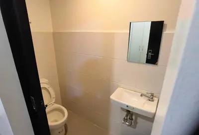 a bathroom with a toilet and a sink and a mirror at Spot On Hostel ,Taguig Manila Formerly MYTOWN HongKong in Manila