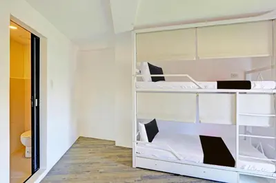 two bunk beds in a room with a toilet at Spot On Hostel ,Taguig Manila Formerly MYTOWN HongKong in Manila