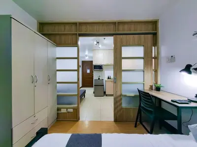 a room with a desk and a room with a bedroom at 1BR Condotel Ridgewood Towers Taguig City #RW04 in Manila