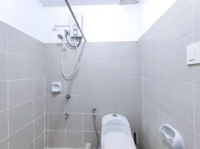 a white bathroom with a shower and a sink at 1BR Condotel Ridgewood Towers Taguig City #RW04 in Manila