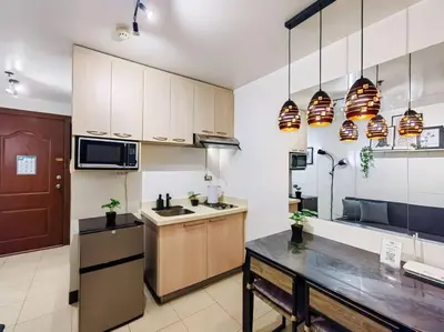 a large kitchen with a sink and a microwave at 1BR Condotel Ridgewood Towers Taguig City #RW04 in Manila
