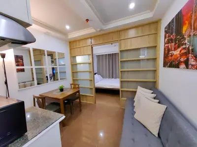 a living room with a couch and a bedroom at 1BR Condotel Ridgewood Towers Taguig City #RW05 in Manila