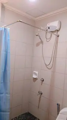 a bathroom with a shower with a shower curtain at 1BR Condotel Ridgewood Towers Taguig City #RW05 in Manila